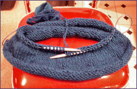 The teal felted hat is growing larger