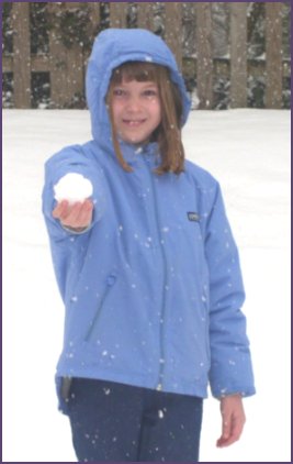 Diana holding a snowball on a snowy day