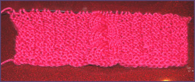 pink cabled square in progress