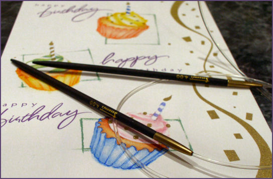 ebony needles on top of birthday card