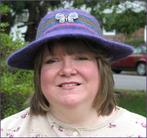 Trish modeling finished hat with butterfly pin