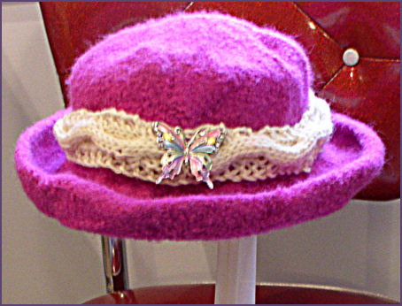 Diana's hat completed with cabled hatband and butterfly pin