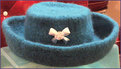 blue felted flat top hat with bowtie pin accent