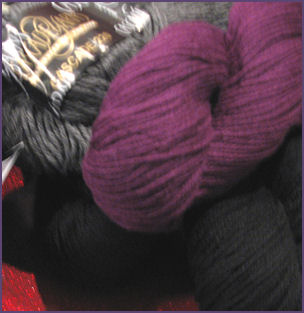 purple yarn, gray yarn, black yarn in hanks