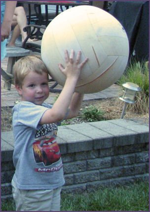 Steven holding large ball over his head