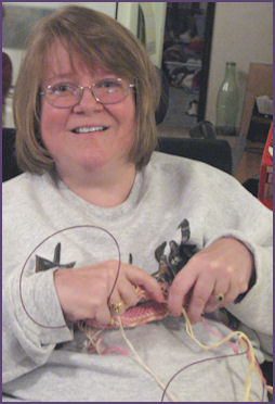 trish knitting a baby hat and new hairdo