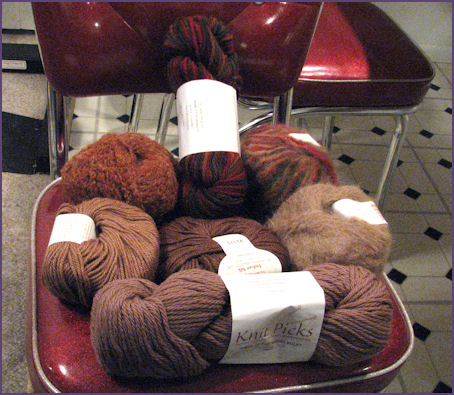 Pile of differently colored and textured brown yarns