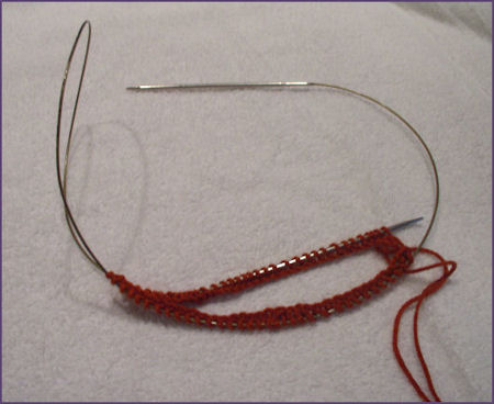 pull the right needle through the stitches to begin knitting