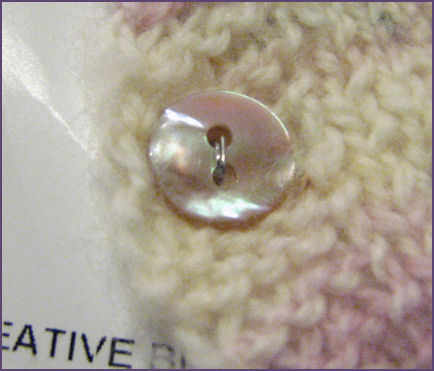 closeup of button for baby sweater