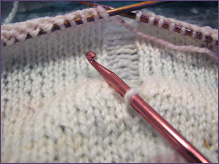 crochet hook inserted in ladder of stitches