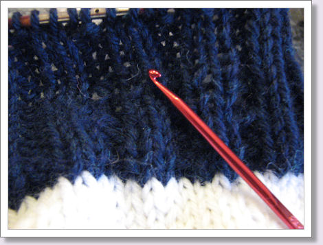 closeup of crochet hook on hat ribbing