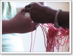 Two hands, tackling some knotty yarn together Two hands, tackling some knotty yarn together