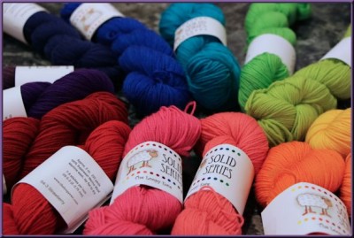multiple skeins of yarn arranged according to the color spectrum