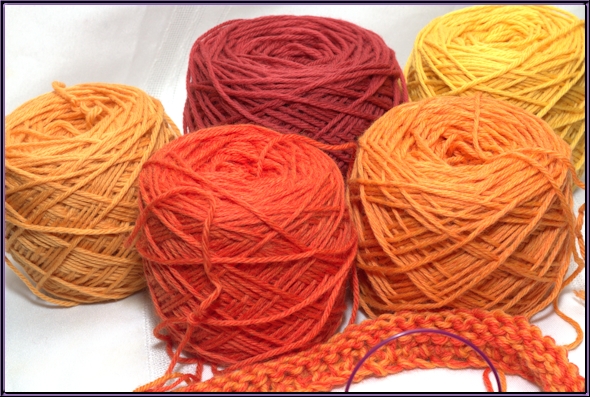 five shades of orange and yellow yarn