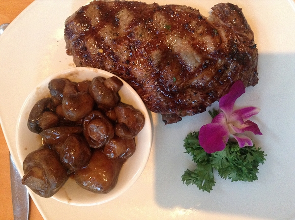 Steak and mushrooms with purple flower