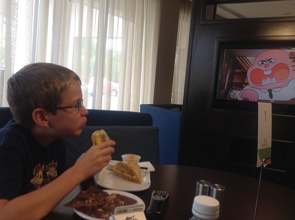 Steven eats breakfast while watching cartoons tableside